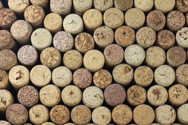 Abstract background of used red wine corks and white wine corks with corkscrew marks
