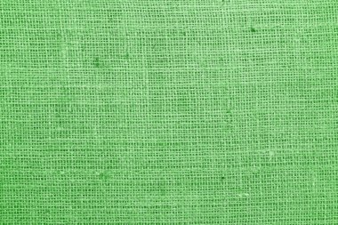 Yeşil bez kumaş, tuvalin üzerinde gerçek keten iplikler ve yeşil keten kumaş örnekleri gibi güzel keten dokular.