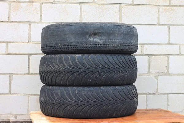 old winter tire as sample of damaged tires from summer and winter tires