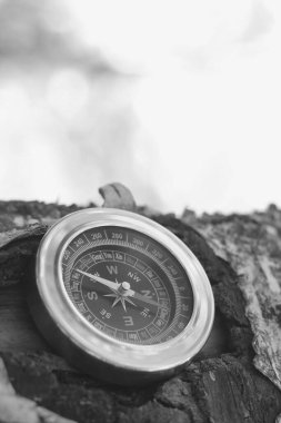 Pusula ile turizmin sembolü olarak siyah ve beyaz fotoğraf, pusula ile seyahat ve pusula ile açık hava aktiviteleri