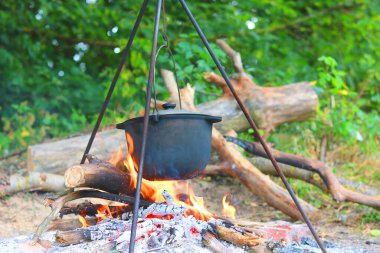 Alevli ateşin üzerinde kamp kuruyorlar.