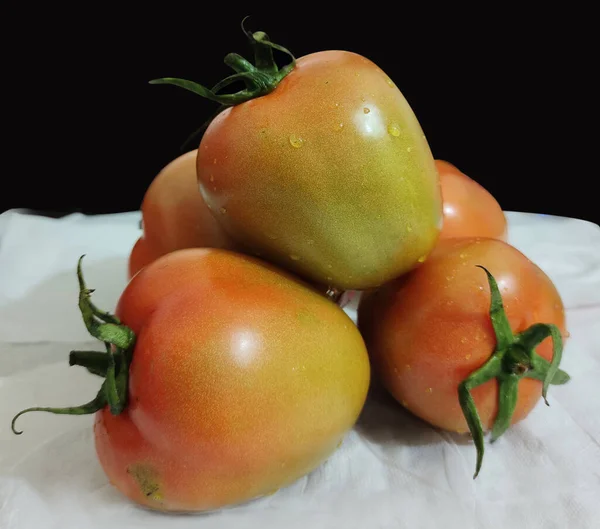 Ripe tomatoes on the background. Fresh big tomato fruit images