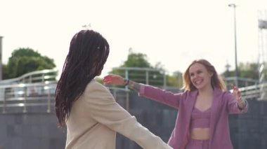 Young african american woman is meeting with a business partner or client and discussing future plans for a project, hugging her friend