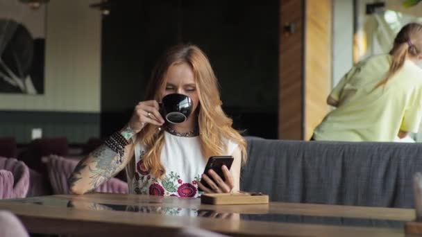 Young Woman Casual Attire Sits Window Cafe Drinking Coffee Looking — Stock Video