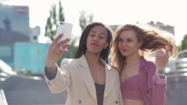 Young african american woman is meeting with business partner or client and discussing future plans for the project, making happy selfie