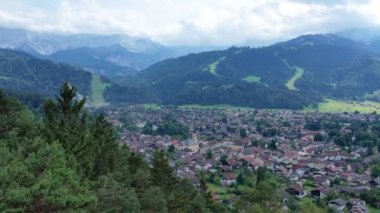 Aerial of Garmisch Partenkirchen Bavarian village in Alps montains. Summer time, long shot