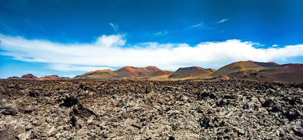 Volcanic landscape and volcano crater at Timanfaya National Park, Lanzarote Island, Canary Spain