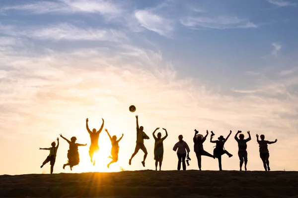 stock image Silhouette of happy business group team over sunset sky. Success and teamwork concept in company with hands up over beautiful sunset sky for business success and teamwork concept in company