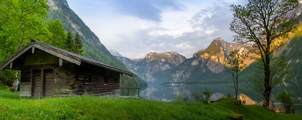 Wooden house on mountain lake Koenigssee Berchtesgaden National Park Bavaria Germany