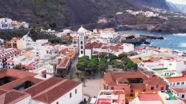Aerial morning view of Garachico city center with colored houses. Old town of Garachico on island of Tenerife, Canary. Ocean shore and lava pools. Popular tourist destination, pearl of the Canary