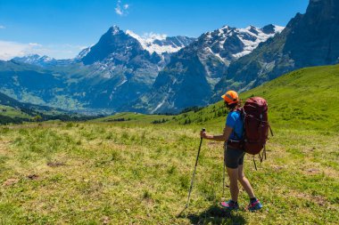 İsviçre Alplerinde yürüyüş yapan sportif bir kadın. Sağlıklı yaşam tarzı, spor, doğadaki güzellik. Grindelwald Vadisi, Swizz