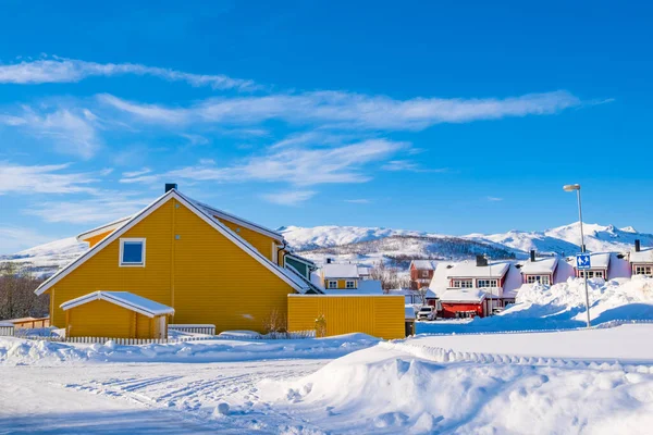 stock image Norwegian traditional houses of Troms in the winter. Snowy arctic city with colorful houses and port