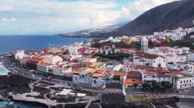 Aerial morning view of Garachico city center with colored houses. Old town of Garachico on island of Tenerife, Canary. Ocean shore and lava pools. Popular tourist destination, pearl of the Canary