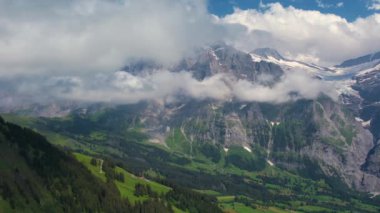 Sinema robotları İsviçre 'nin Bernese Alplerindeki Grindelwald vadisi ve yeşil çayır üzerinde uçar.