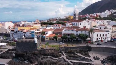 Aerial morning view of Garachico city center with colored houses. Old town of Garachico on island of Tenerife, Canary. Ocean shore and lava pools. Popular tourist destination, pearl of the Canary