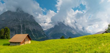 View on the alpine valley Grindelwald. Jungfrau, Switzerland. Under the Bernese alps. Mountain village. clipart