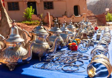 Multicolored Moroccan craft souvenirs at the market. Teapots and plates , decorations, tagines,, trinkets