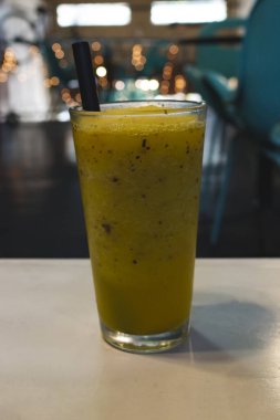 Bir bardak meyve suyu masada oturuyor.