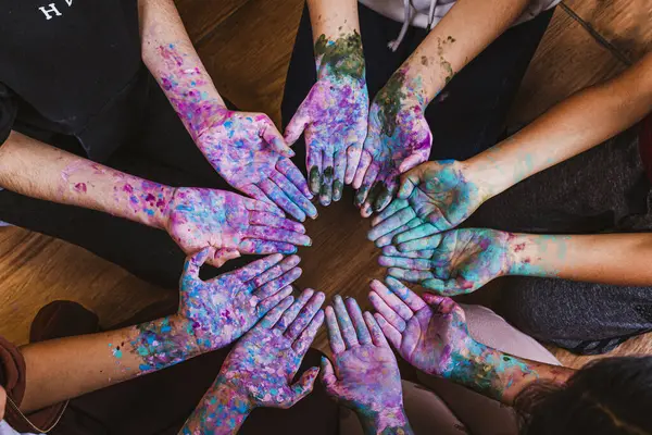a group of people with their hands painted in a circle