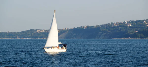 pleasure yacht with a sail in the sea bay in sunny day