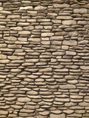 stone gray wall of old house for natural vertical background.