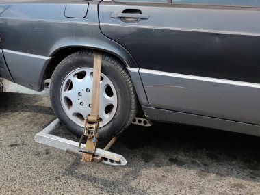 blocking the car wheel during transportation close-up.