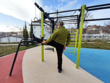 workout, man stretching his legs on the street sports ground