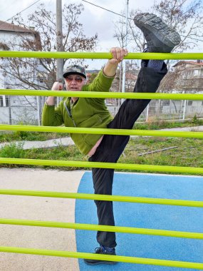 workout, man doing stretching on a street sports ground