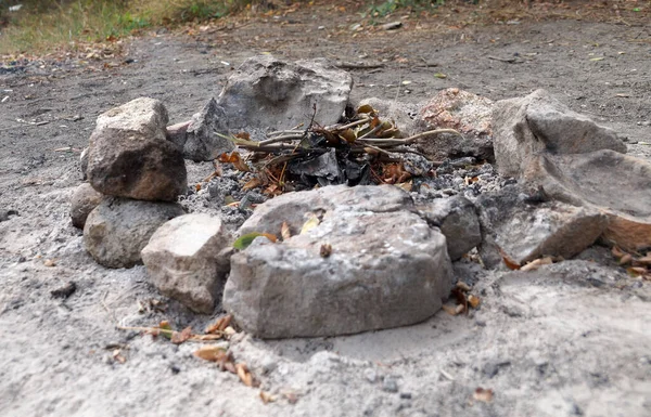 an extinct fire pit surrounded by stones close-up
