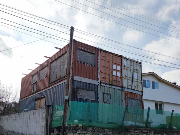 unfinished residential building from shipping containers, alternative modular housing construction.