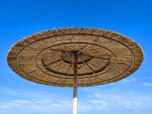 Arka Planda Saman Plajı Şemsiyesi Açık Mavi Bir Gökyüzü Yakın — Stok fotoğraf
