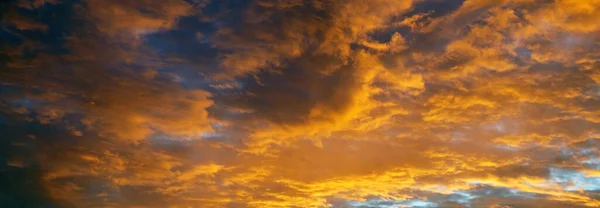 yellow clouds at sunset, horizontal sky background.