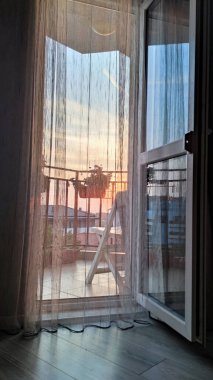 open balcony door, sunrise behind a light transparent curtain. clipart