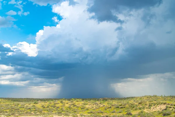 Thunderstorm unusual cloud over the Kyzylkum desert, rare rain over the desert area