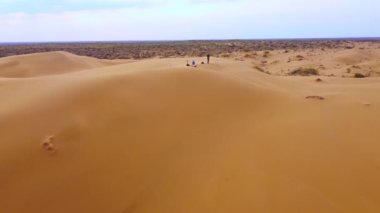 Flight over the dunes in the desert. beautiful top view of the Kyzyl Kum desert in kazakhstan at sunrise. Oriental landscapes of Central Asia, a lifeless arid area without water