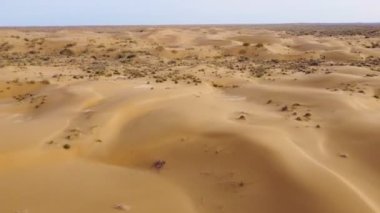 Flight over the dunes in the desert. beautiful top view of the Kyzyl Kum desert in kazakhstan at sunrise. Oriental landscapes of Central Asia, a lifeless arid area without water