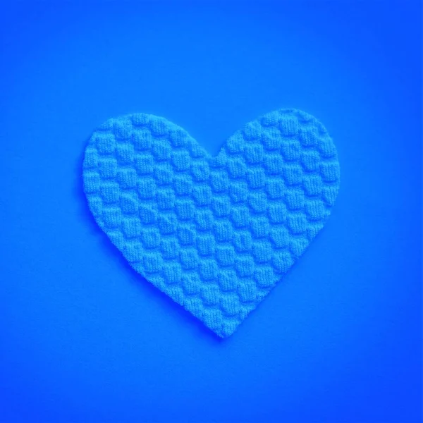Fabric heart on neon blue table. Art card.
