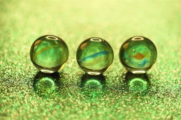 Three Glass Balls Glitter Green Table — Stock Photo, Image