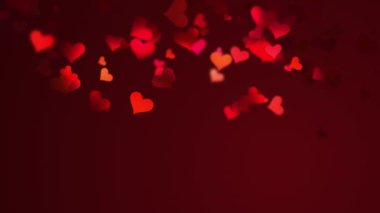 Blurred romantic dark background with flying red hearts in the light of night lanterns. for valentines festival of love.