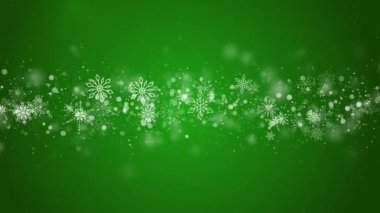 Yeşil Noel tatili arka planında beyaz kar taneleri ve bulanık parçacıklar var. Döngülü canlandırma.