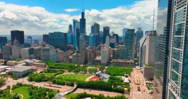 Chicago, Illinois, ABD - 01 Haziran 2024: Chicago 'daki Millennium Park' taki Bulut Kapısı. Şehir merkezindeki yeşil parkın ve gökdelenlerin havadan görünüşü.