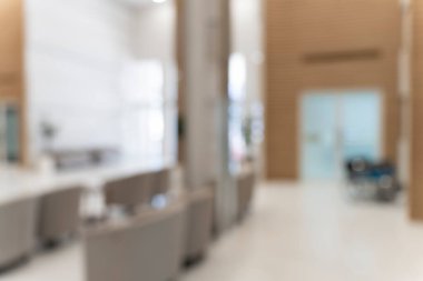 Hastane ya da klinikteki koridorun bulanık görüntüsü, muayene odasının yakınındaki bekleme alanında karşı bilgi ve kanepe, görüntüde kimse yok.