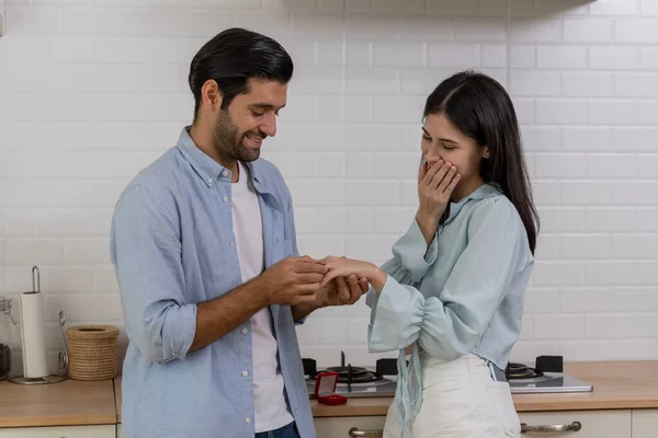 Romantic lover in kitchen, Young handsome man making proposal give a ring to surprise his girlfriend for ask her to marry at home, They will marry together