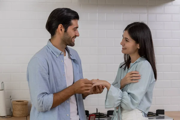 Romantic lover in kitchen, Young handsome man making proposal give a ring to surprise his girlfriend for ask her to marry at home, They will marry together