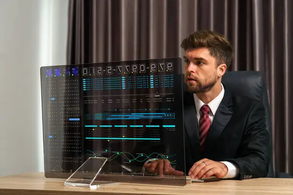 A businessman looks at sales analytical charts on a transparent monitor. The shows a positive trend, indicating that the business is doing well,