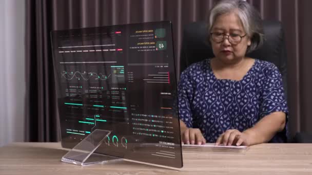 シニアビジネスマンは オフィスで透明なモニターを備えたデスクトップコンピュータを使用し 彼女の創造的なアイデアで明らかに彼女の仕事への革新的なアプローチ — ストック動画