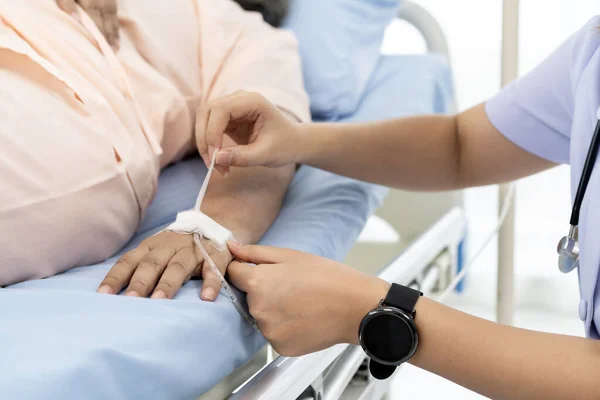 Hospitalization of the patient. Nurse takes care of patients in nursing home or hospital. nurse are verifying the accuracy of giving Saline to patients. Caregiver or nurse and senior concept.