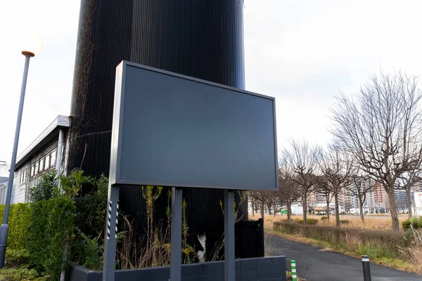 blank billboard in front of a building, perfect for mockup or advertising.