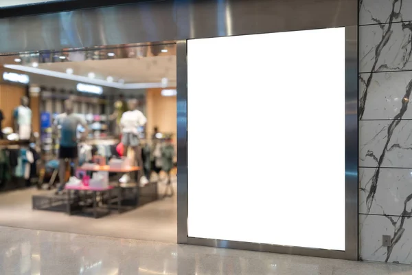 Mockup of a blank billboard at Front of sport ware store in Shopping Mall. Perfect for showcasing your logo and branding.