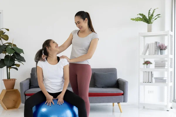 a supportive and encouraging personal training experience, as a female personal trainer and her client share a heartwarming smile after a productive workout session.